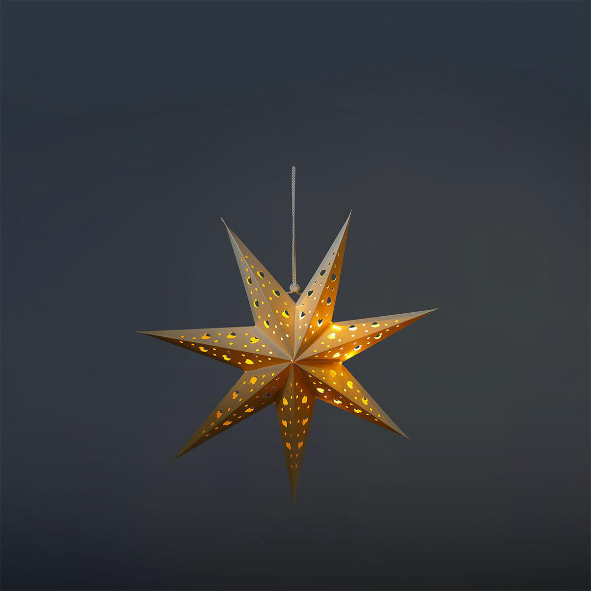 White glowing paper star from Flying Tiger Copenhagen, ideal for home decor and ambient lighting.