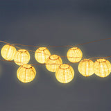 Outdoor string lights with striped fabric ball covers, ideal for home décor and outdoor ambiance by Flying Tiger Copenhagen.