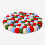 Colorful wool trivet in mixed colors, 19 cm kitchen accessory by Flying Tiger Copenhagen, shown on a countertop.