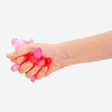 Pink splatter Press Me gadget toy from Flying Tiger Copenhagen, featuring a colorful, squeezable design for stress relief.