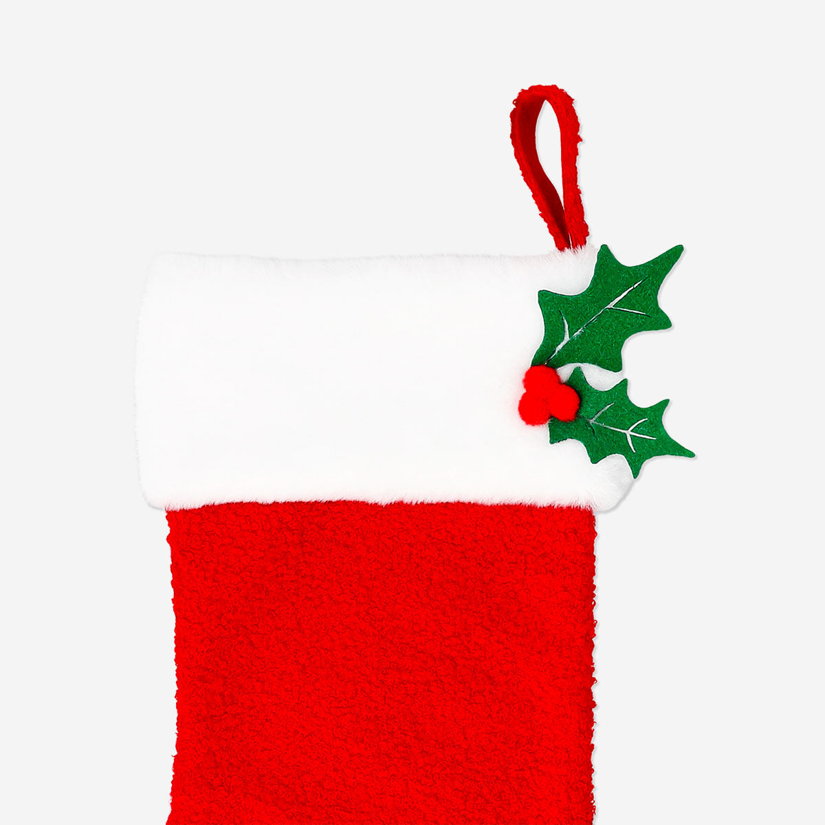 Red bouclé Christmas stocking from Flying Tiger Copenhagen, hanging with a cozy, textured home decor style.