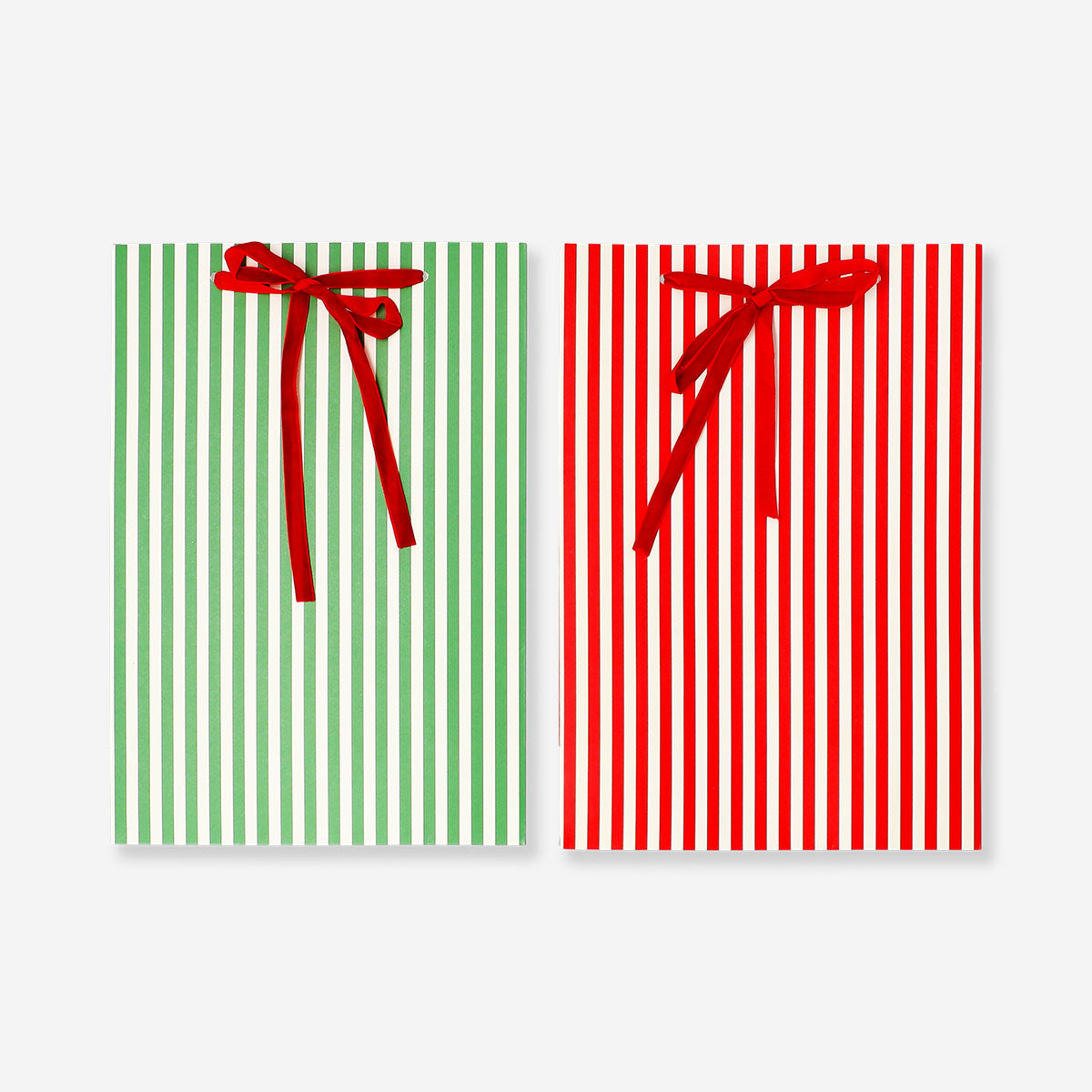Two office gift bags with colorful striped design and ribbon handles, perfect for gift wrapping from Flying Tiger Copenhagen.