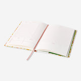 A5 floral office planner by Flying Tiger Copenhagen with colorful floral cover and organized interior pages.