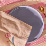 Two fabric napkins with colorful flower designs from Flying Tiger Copenhagen, perfect for home table settings.