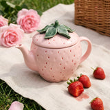 Pink strawberry-shaped teapot with lid from Flying Tiger Copenhagen, suitable for kitchen use and tea serving.