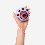 Purple handheld fan gadget with paw design by Flying Tiger Copenhagen, compact and portable for cooling on the go.