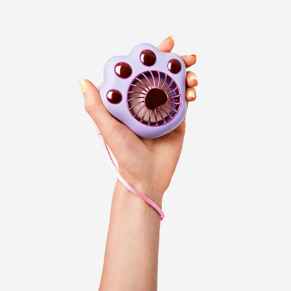Purple handheld fan gadget with paw design by Flying Tiger Copenhagen, compact and portable for cooling on the go.