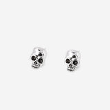 Silver skull stud earrings with textile backing from Flying Tiger Copenhagen, featuring a detailed skull design.