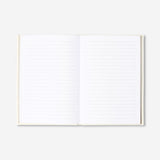 A5 white office notebook with a fabric cover by Flying Tiger Copenhagen, showing the textured fabric surface and closed binding.
