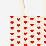 Flying Tiger Copenhagen heart print textile tote bag with sturdy handles, featuring a playful heart pattern on durable fabric.