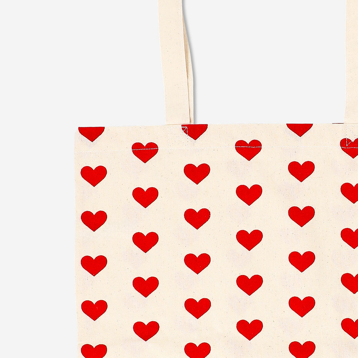 Flying Tiger Copenhagen heart print textile tote bag with sturdy handles, featuring a playful heart pattern on durable fabric.