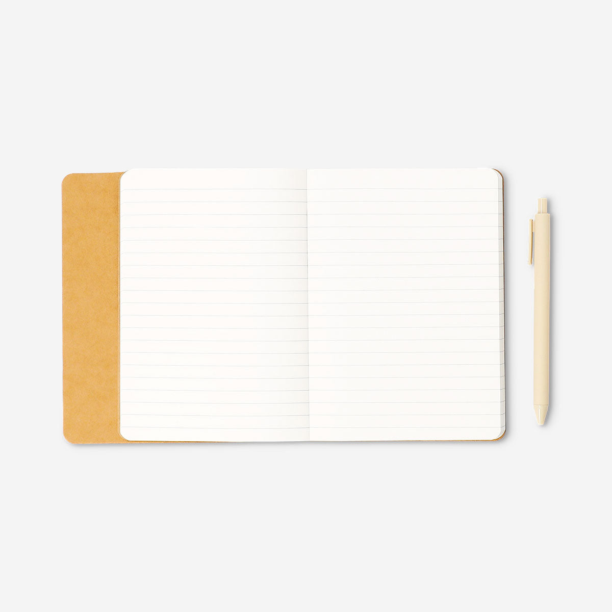 Butter yellow office notebook with a matching ballpoint pen from Flying Tiger Copenhagen, open showing lined pages.