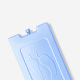 Blue ice block from Flying Tiger Copenhagen placed on a kitchen countertop, showcasing its solid, transparent ice appearance.