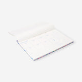 Floral weekly planner 2027 from Flying Tiger Copenhagen, featuring colorful floral cover and weekly layout for office organization.