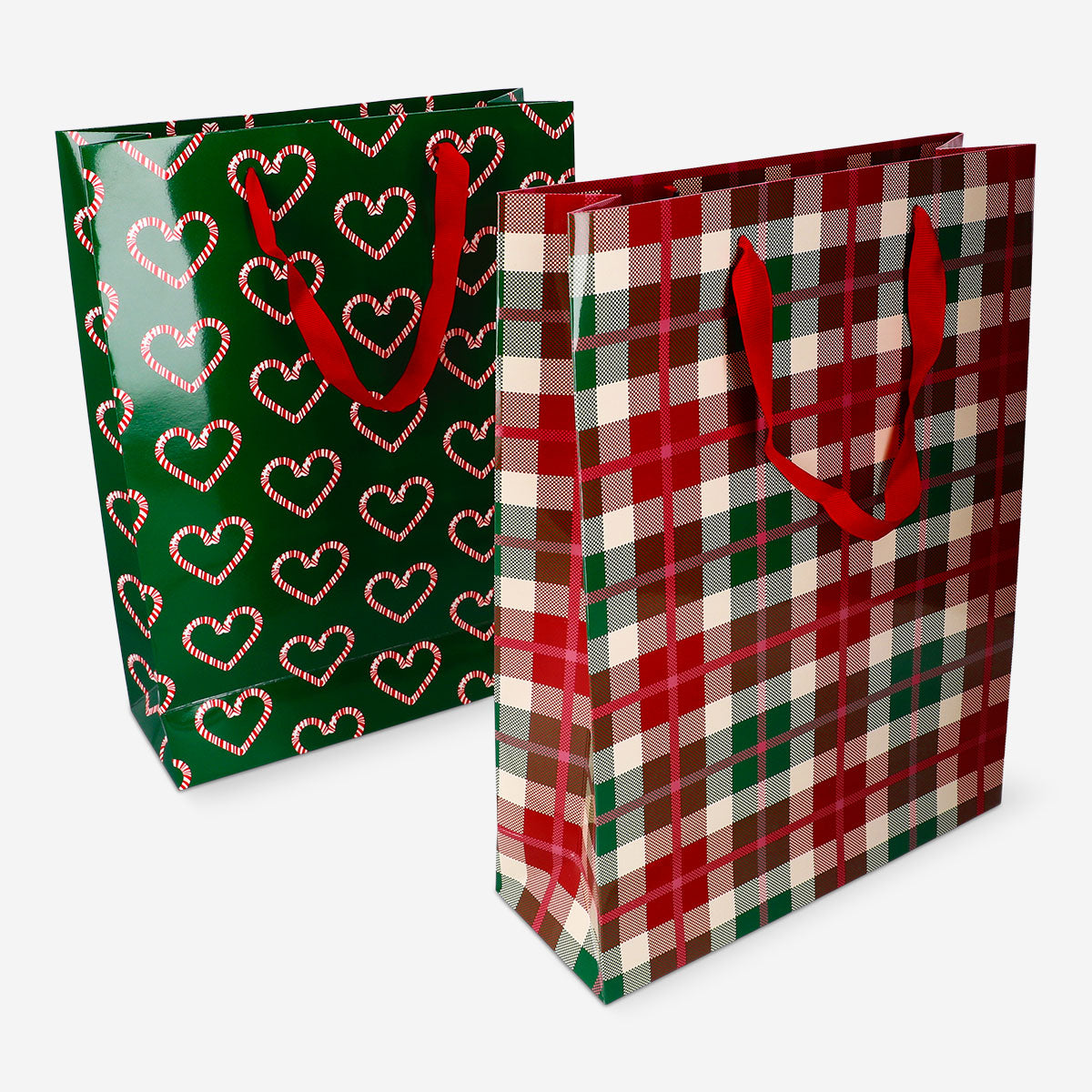 Two Flying Tiger Copenhagen Christmas print gift bags, coated with festive holiday designs, suitable for office gift wrapping.