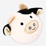 Soft plush ball toy in the shape of a cow from Flying Tiger Copenhagen, featuring a cute cow face and pastel-colored patches.