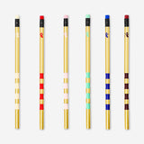 Set of six gold-colored office pencils from Flying Tiger Copenhagen arranged on a white background.