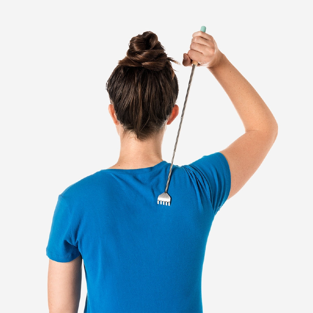 Pink telescopic back scratcher gadget from Flying Tiger Copenhagen, extended to reach and scratch your back comfortably.
