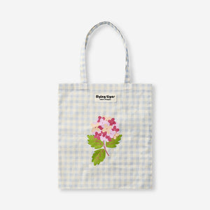 Flying Tiger Copenhagen tote bag with colorful floral and checkered textile print, featuring sturdy handles for everyday use.