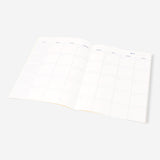 A4 floral monthly planner from Flying Tiger Copenhagen, open to show colorful floral pages and calendar layout.