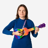 Colorful Rainbow ukulele with strap by Flying Tiger Copenhagen, showing the vibrant instrument and its adjustable strap.