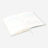 Flying Tiger Copenhagen floral wellness journal for office use, featuring colorful floral cover and lined pages for daily journaling.