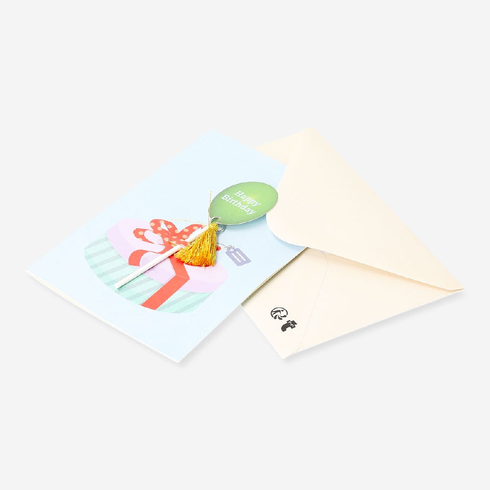 Office birthday card featuring a colorful balloon with tassel attachment from Flying Tiger Copenhagen, displayed on a plain background.
