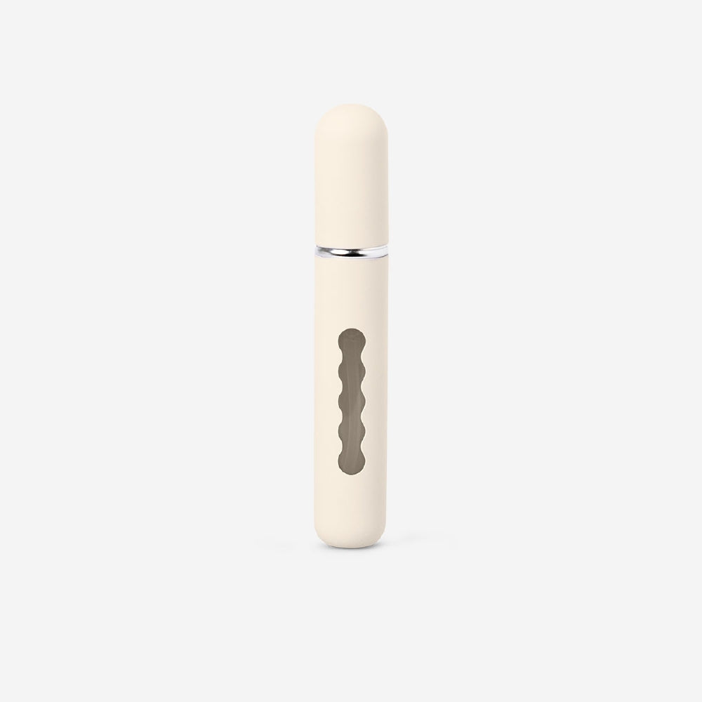 Beige 8ml refillable travel perfume bottle by Flying Tiger Copenhagen, compact and stylish for on-the-go fragrance.