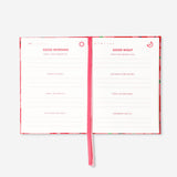 Red floral gratitude journal from Flying Tiger Copenhagen, designed for office use, with a decorative floral cover and lined pages.