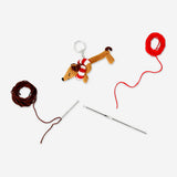 Colorful DIY crochet mini dog hobby kit by Flying Tiger Copenhagen, featuring yarn and crochet tools for crafting a small dog figure.
