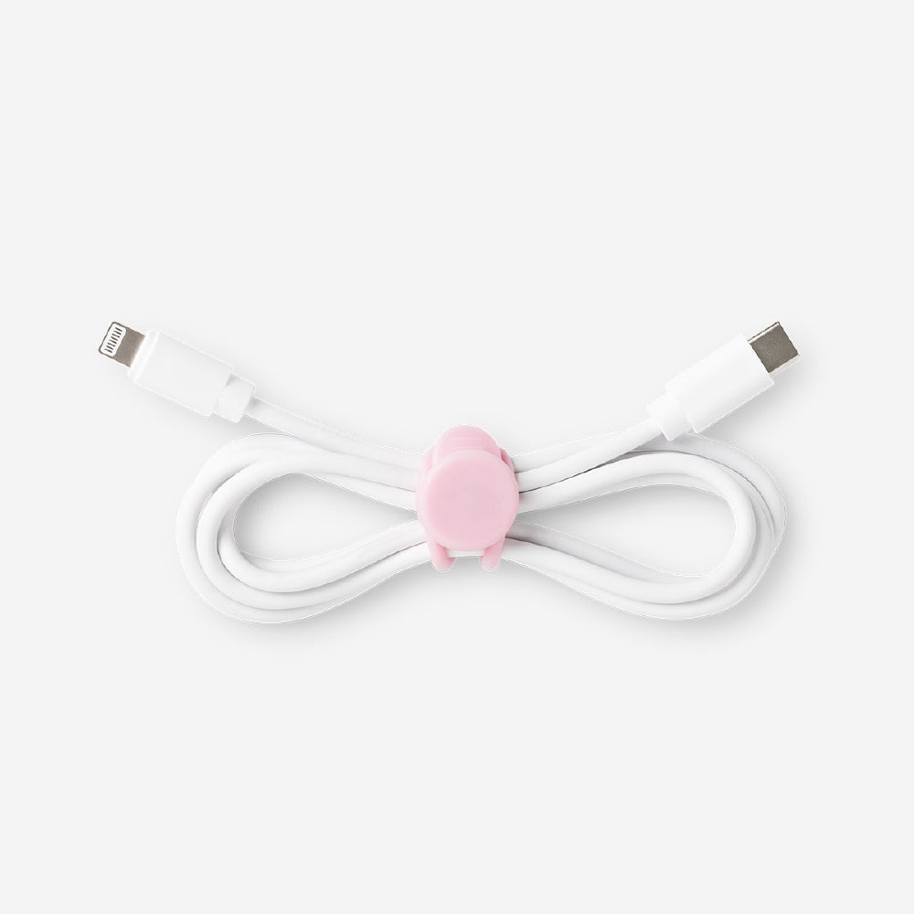 Set of four pink media cable organizers by Flying Tiger Copenhagen, neatly arranged to keep cables tidy and tangle-free.