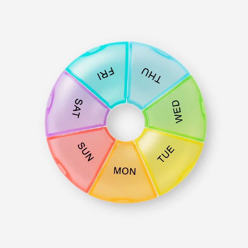Weekly rainbow pill organizer by Flying Tiger Copenhagen with colorful compartments for easy medication management.