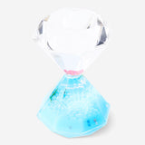 Decorative blue hourglass gadget from Flying Tiger Copenhagen with flowing sand, ideal for home decor or as a desk accessory.