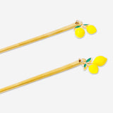 Set of two gold dessert spoons with lemon decoration from Flying Tiger Copenhagen, ideal for serving desserts.
