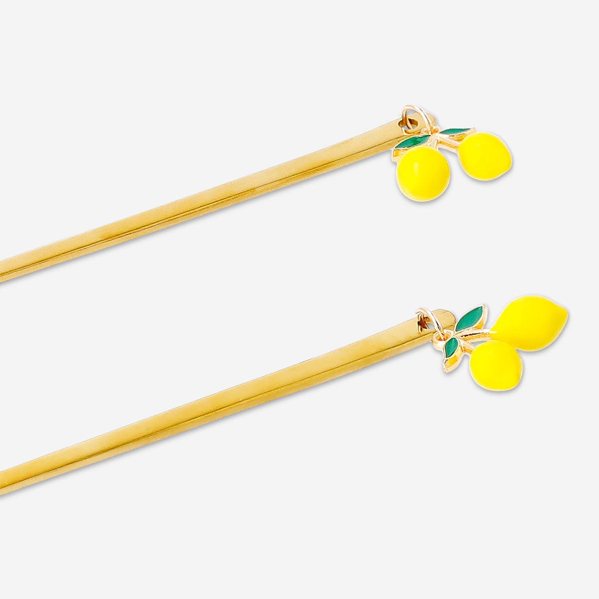Set of two gold dessert spoons with lemon decoration from Flying Tiger Copenhagen, ideal for serving desserts.