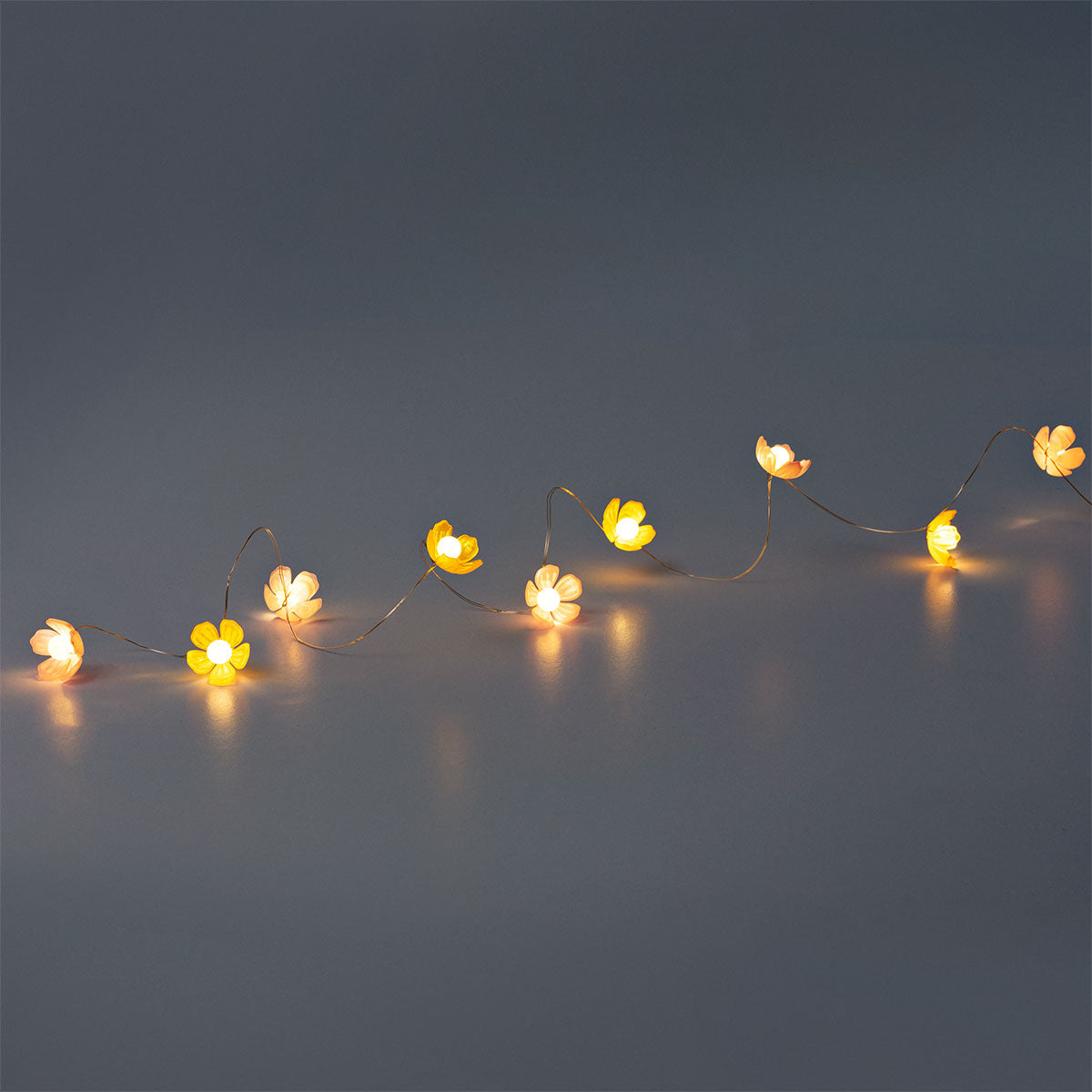 Flying Tiger Copenhagen pink and yellow floral string lights for home decor, featuring colorful flower designs on a length of string lights.