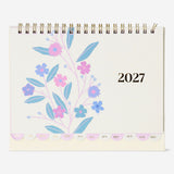 Monthly floral desk calendar for 2027 by Flying Tiger Copenhagen, featuring colorful floral designs and sticker accents for office use.