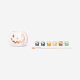 DIY pumpkin tealight holder with painted orange pumpkin design and paintbrush, perfect for creative autumn decorations.