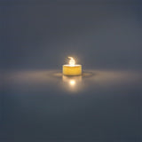 Set of four white LED tealights for home decor, energy-efficient candles by Flying Tiger Copenhagen displayed in a cozy setting.