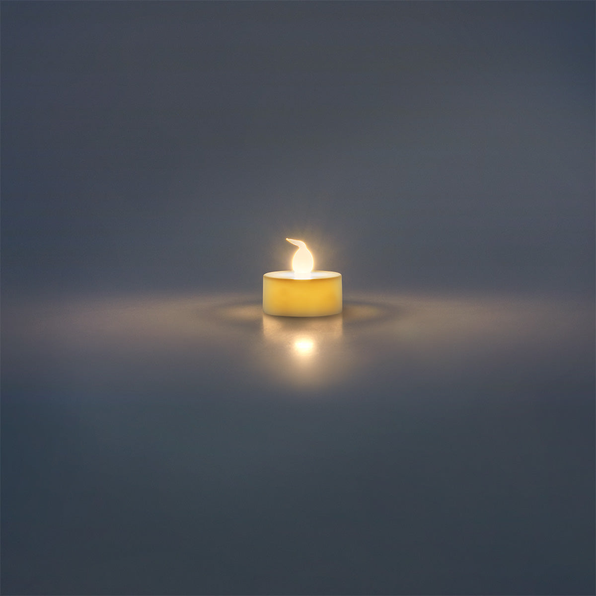 Set of four white LED tealights for home decor, energy-efficient candles by Flying Tiger Copenhagen displayed in a cozy setting.