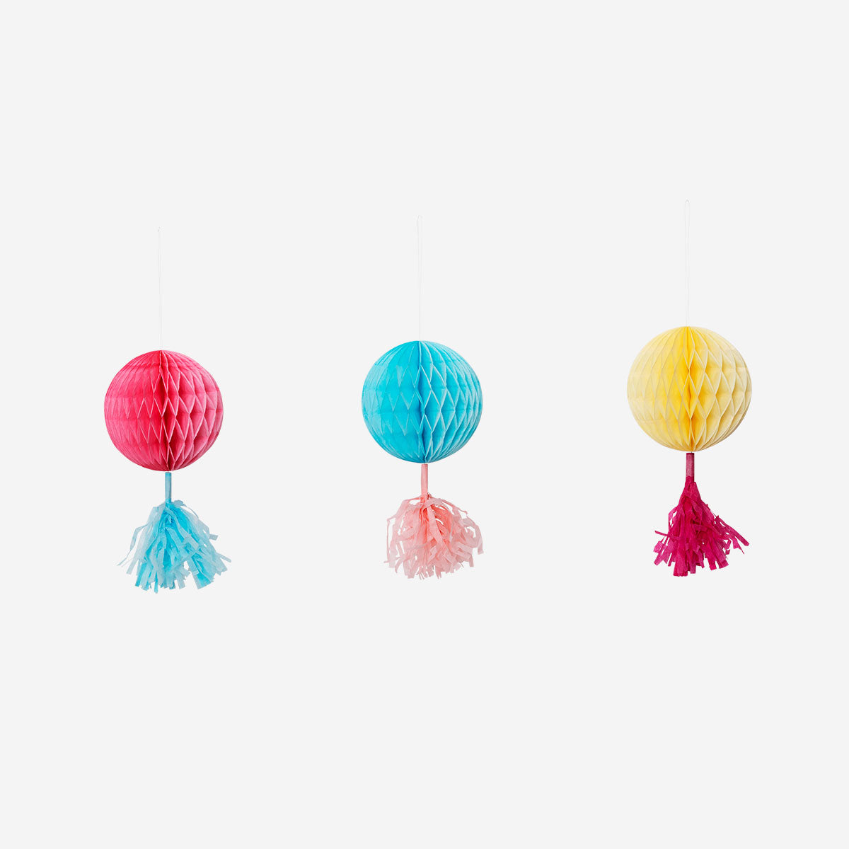 Three colorful paper pom poms for hanging, vibrant party decorations by Flying Tiger Copenhagen