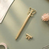 Gold ballpoint pen with butterfly design, Flying Tiger Copenhagen office accessory, featuring a sleek metallic finish.