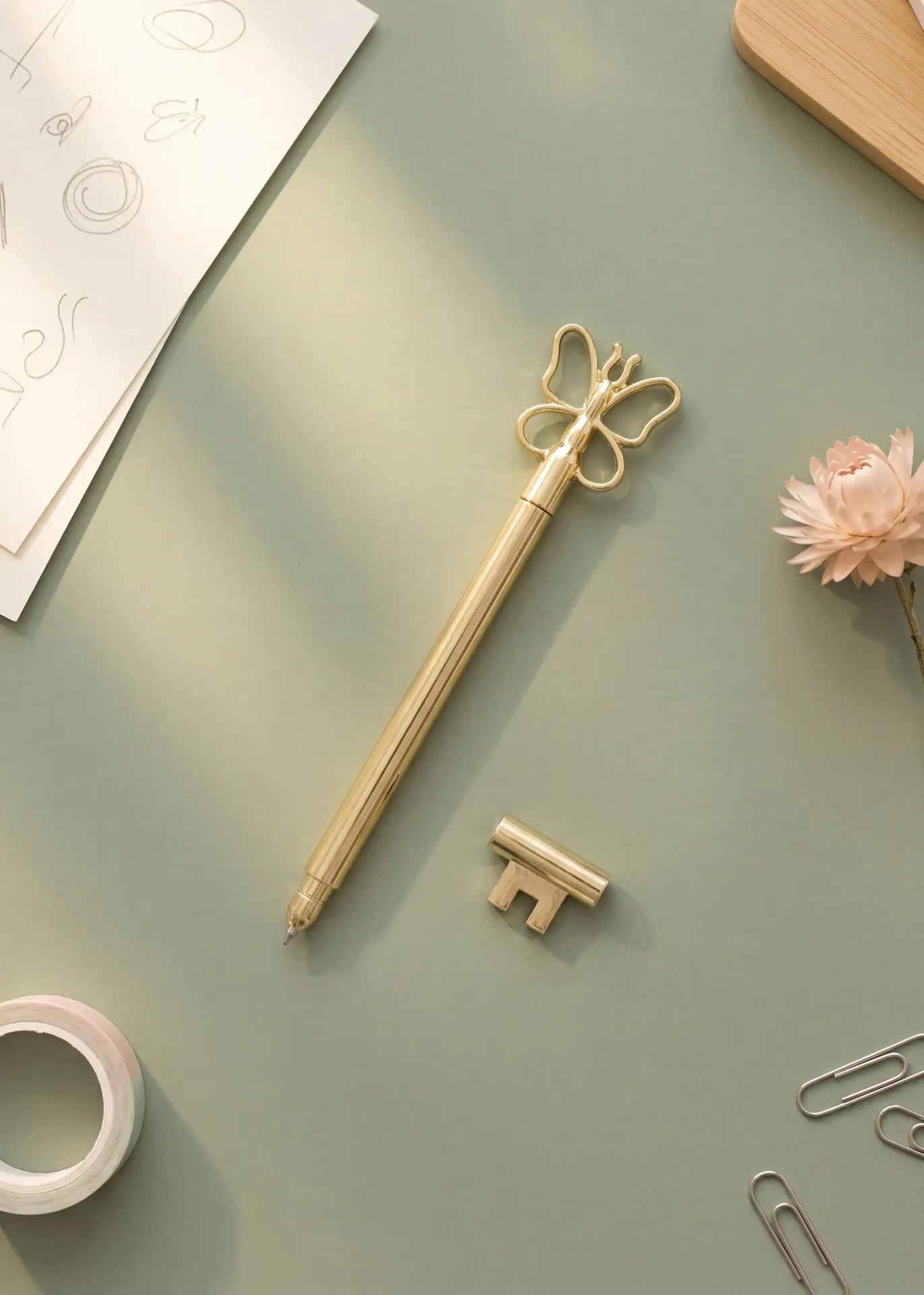 Gold ballpoint pen with butterfly design, Flying Tiger Copenhagen office accessory, featuring a sleek metallic finish.