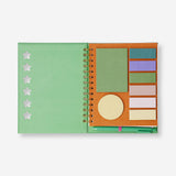 Green Flying Tiger Copenhagen office notebook with attached ballpoint pen and memos for note-taking and organization.