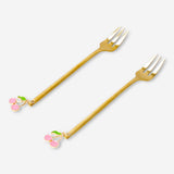 Two gold dessert forks with cherry-shaped decorations from Flying Tiger Copenhagen, perfect for elegant kitchen serving.