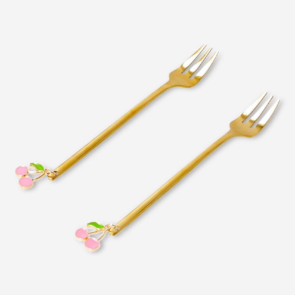 Two gold dessert forks with cherry-shaped decorations from Flying Tiger Copenhagen, perfect for elegant kitchen serving.