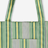 Green mesh shopper bag with striped textile design by Flying Tiger Copenhagen, featuring a lightweight, breathable, eco-friendly tote.