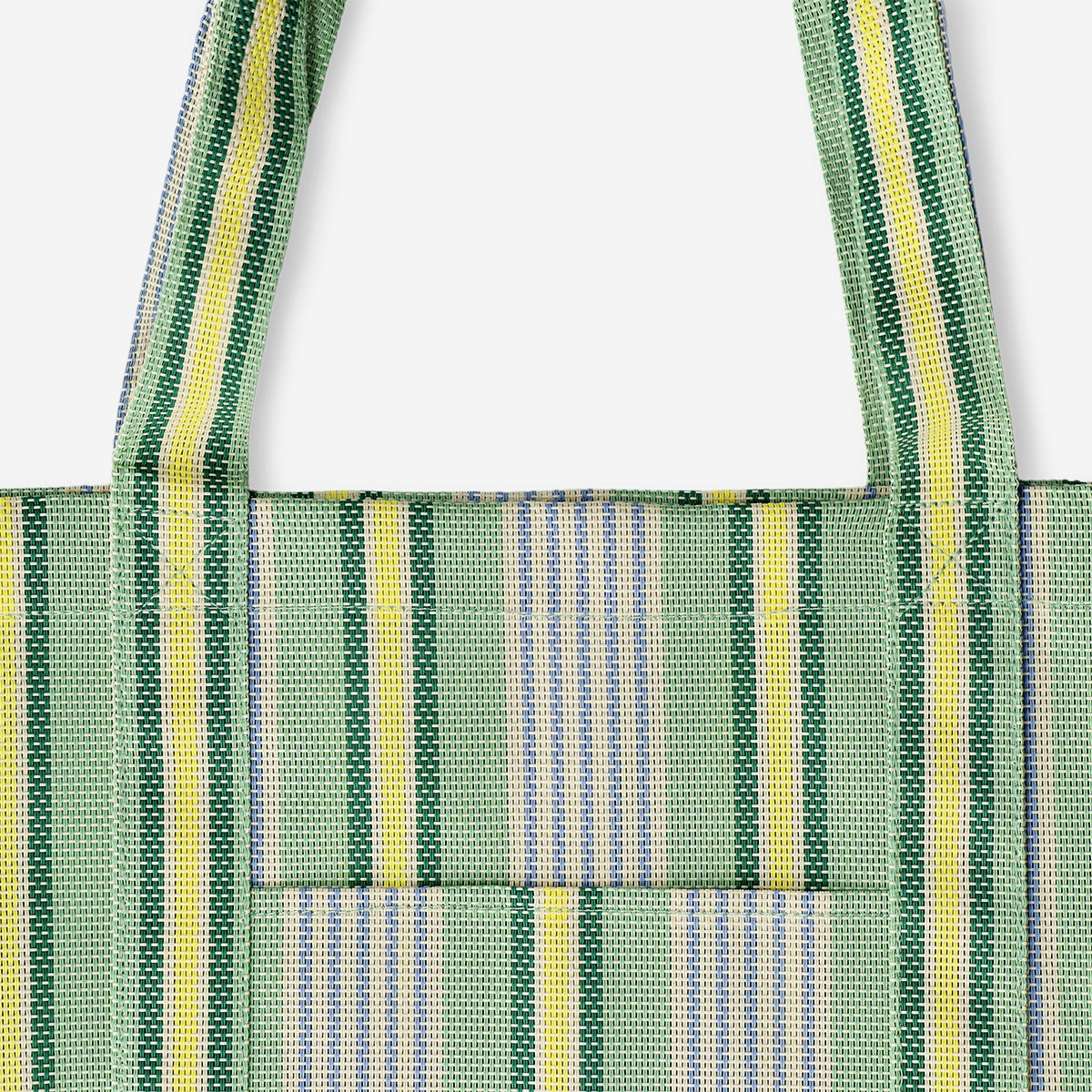 Green mesh shopper bag with striped textile design by Flying Tiger Copenhagen, featuring a lightweight, breathable, eco-friendly tote.
