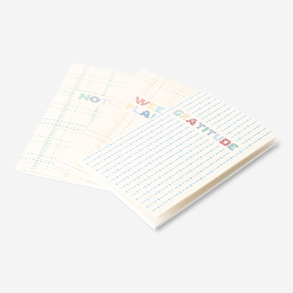 Set of three Flying Tiger Copenhagen office planners with colorful covers and pages for organizing daily tasks and schedules.