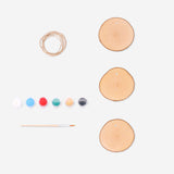 Set of three DIY wooden ornaments from Flying Tiger Copenhagen, showcasing natural wood textures for craft projects.